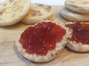 Homemade English Muffins topped with strawberry jam